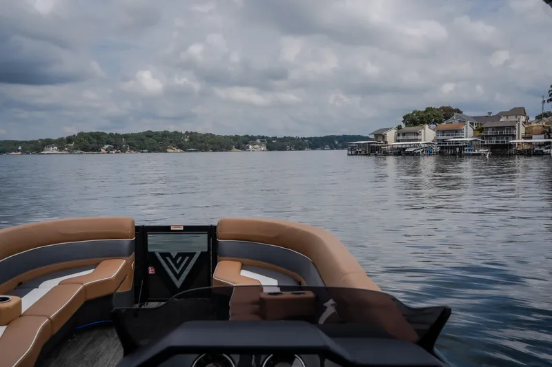 Slide: The Image of Viaggio Diamante U 26 boat on a serene lake with waterfront homes, 2026 model. - 49