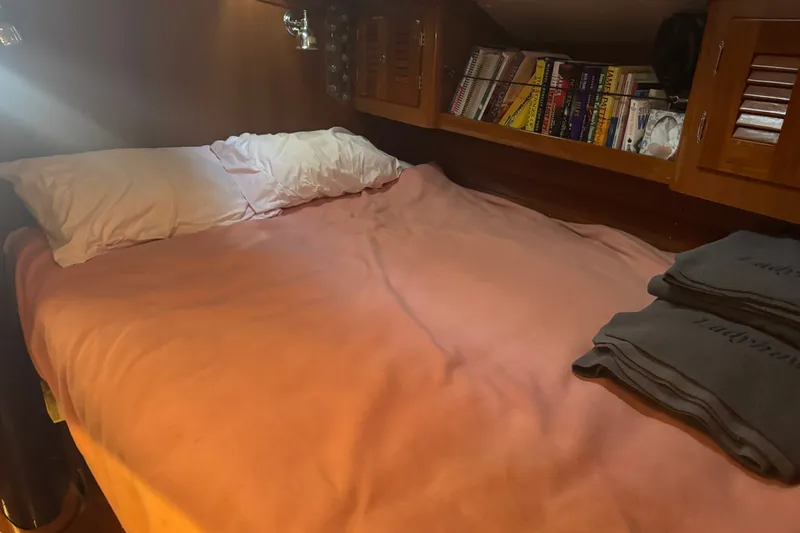 Slide: The Image of Cozy cabin interior of 2020 J Boats J/160 with bed and bookshelf. - 6