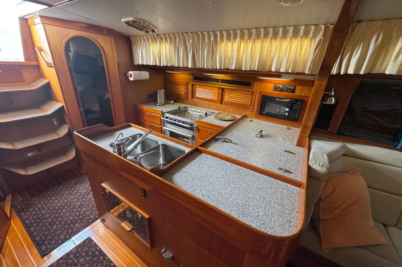 Slide: The Image of Luxurious 1998 J Boats J/160 yacht interior with modern kitchen and cozy seating area. - 15