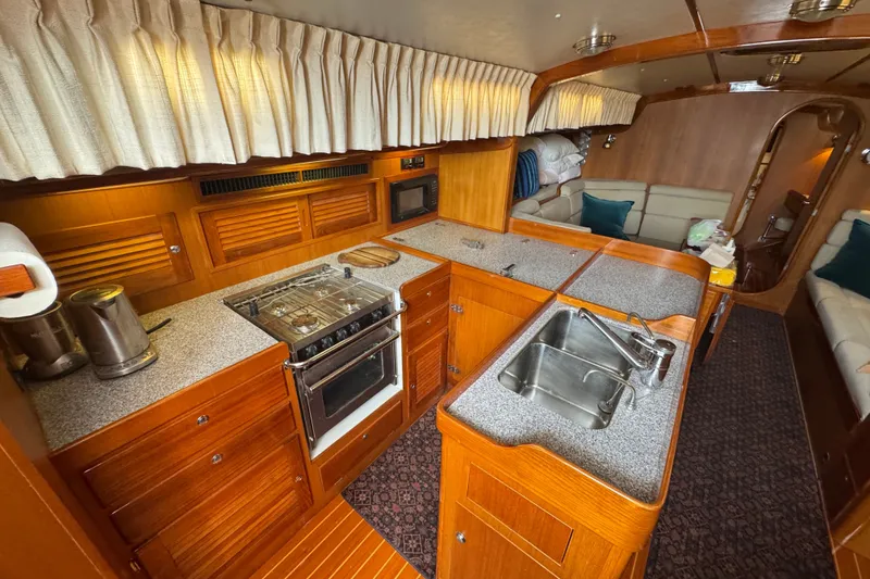 Slide: The Image of Luxurious interior of 2020 J Boats J/160 yacht featuring a modern kitchen and cozy seating area. - 2