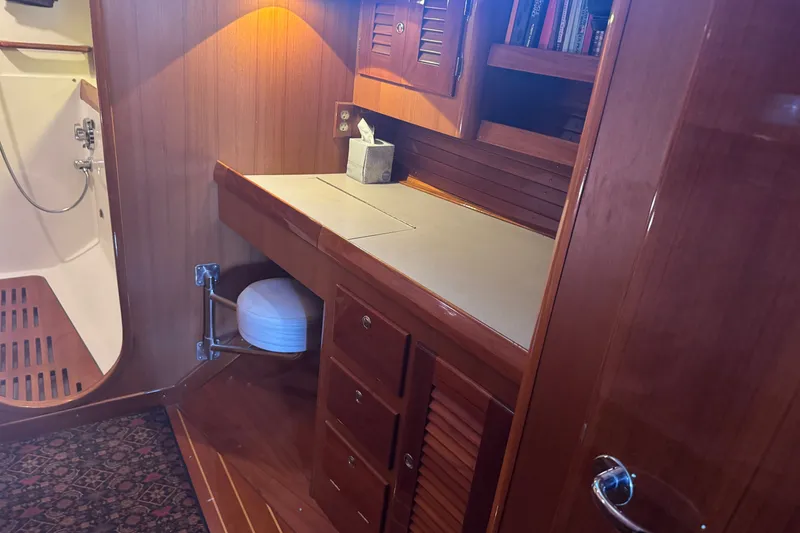 Slide: The Image of Luxurious wooden interior of 2020 J Boats J/160 yacht with desk and shower area. - 7