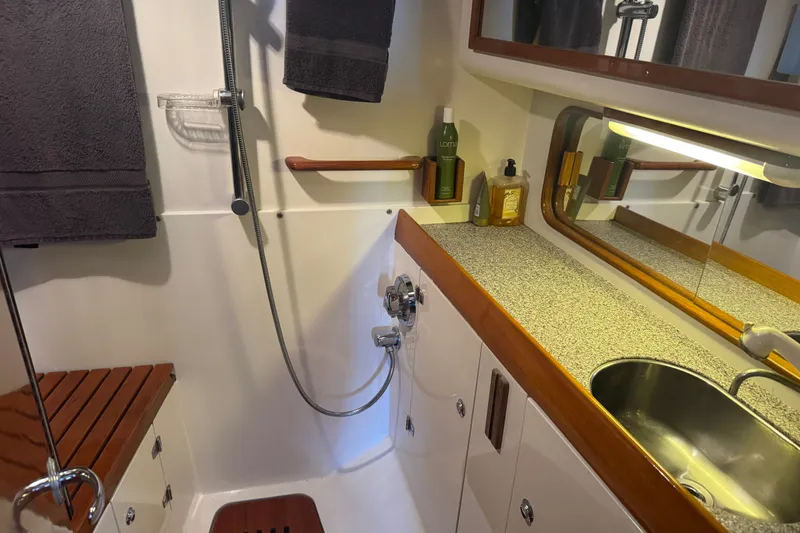 Slide: The Image of Luxurious bathroom interior of 2020 J Boats J/160 yacht with modern fixtures and wooden accents. - 8