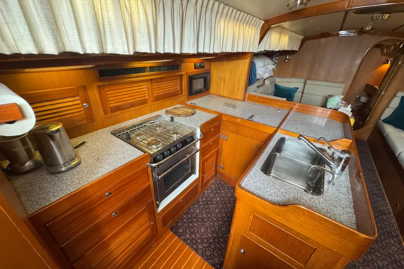 Slide: The Image of Interior of 2020 J Boats J/160 yacht featuring a well-equipped kitchen galley. - 14