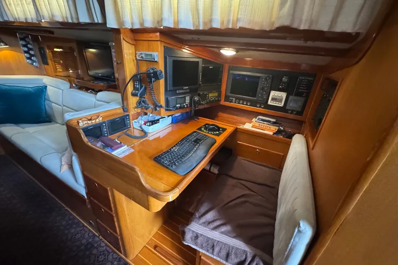 Slide: The Image of Navigation station inside a 1998 J Boats J/160 yacht, featuring control panels and seating. - 3