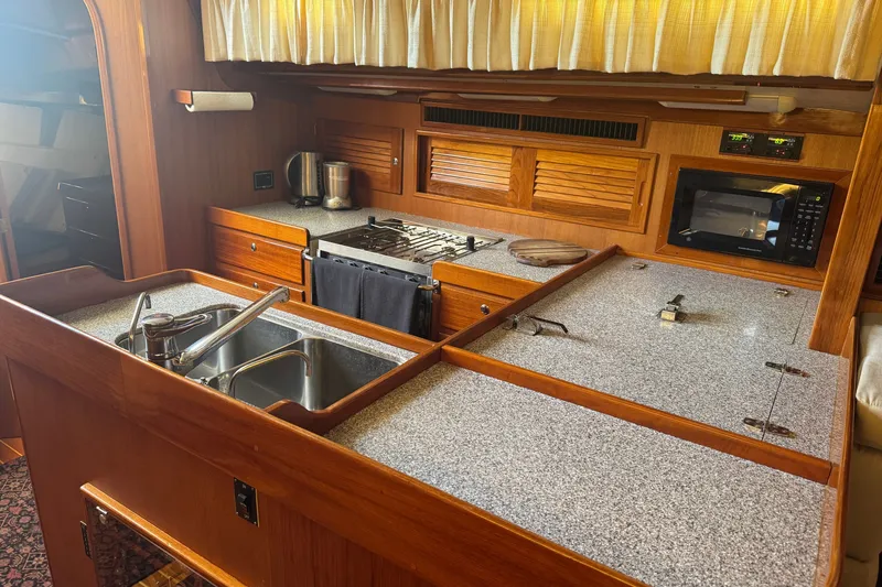 Slide: The Image of Luxurious 2020 J Boats J/160 yacht kitchen with modern appliances and elegant wood finish. - 11