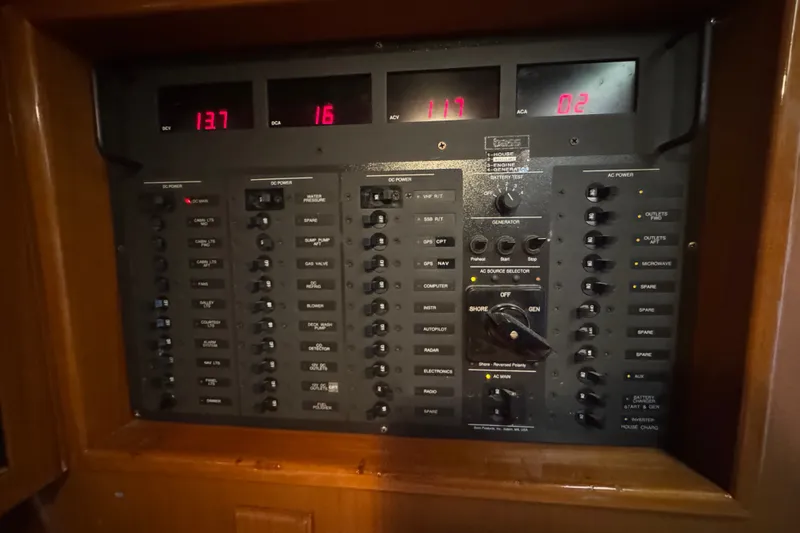 Slide: The Image of Electrical control panel on a 1998 J Boats J/160 yacht, featuring various switches and displays. - 20