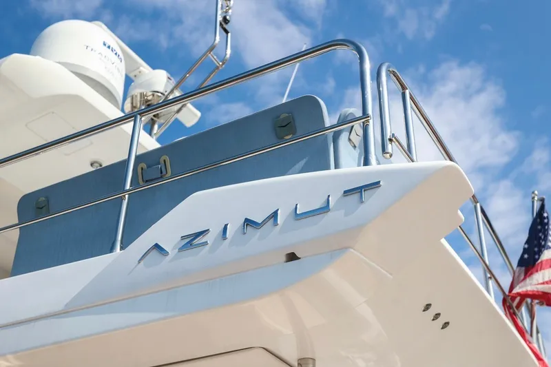 Slide: The Image of 2023 Azimut Fly 50 yacht with American flag, blue sky background. - 14