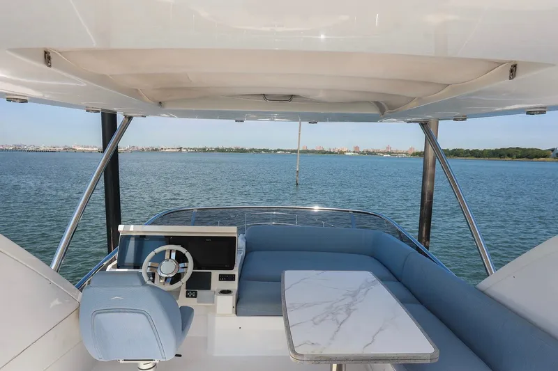 Slide: The Image of Flybridge view of 2023 Azimut Fly 50 yacht with elegant seating and steering area. - 20