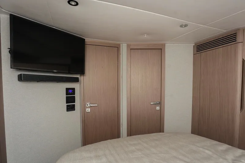 Slide: The Image of Interior of 2023 Azimut Fly 50 yacht with TV, soundbar, and wooden doors. - 24