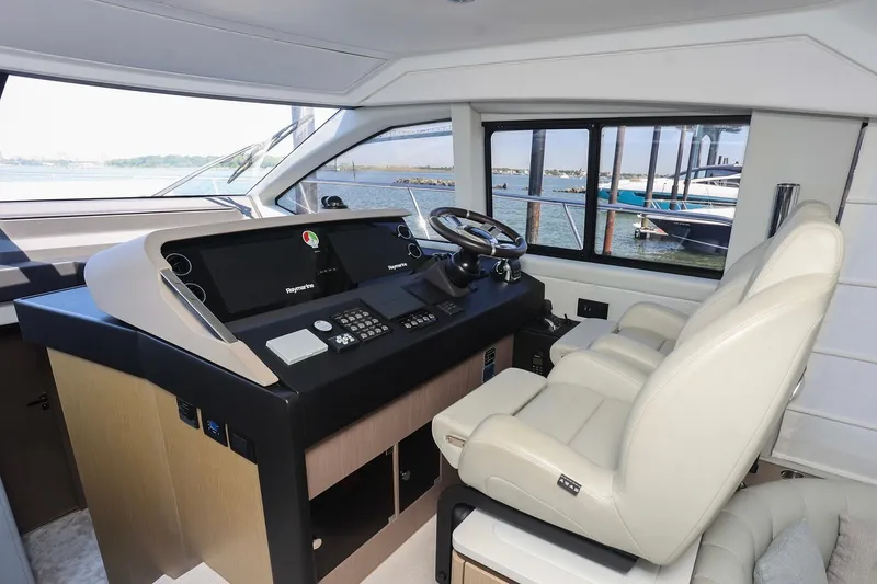 Slide: The Image of Interior helm of 2023 Azimut Fly 50 yacht with modern controls and leather seating. - 43