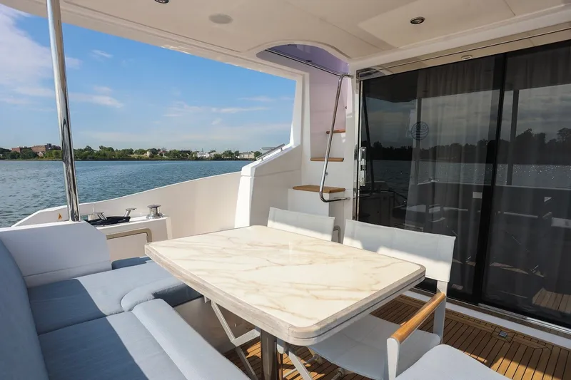 Slide: The Image of Luxurious 2023 Azimut Fly 50 yacht deck with elegant seating and scenic water view. - 51