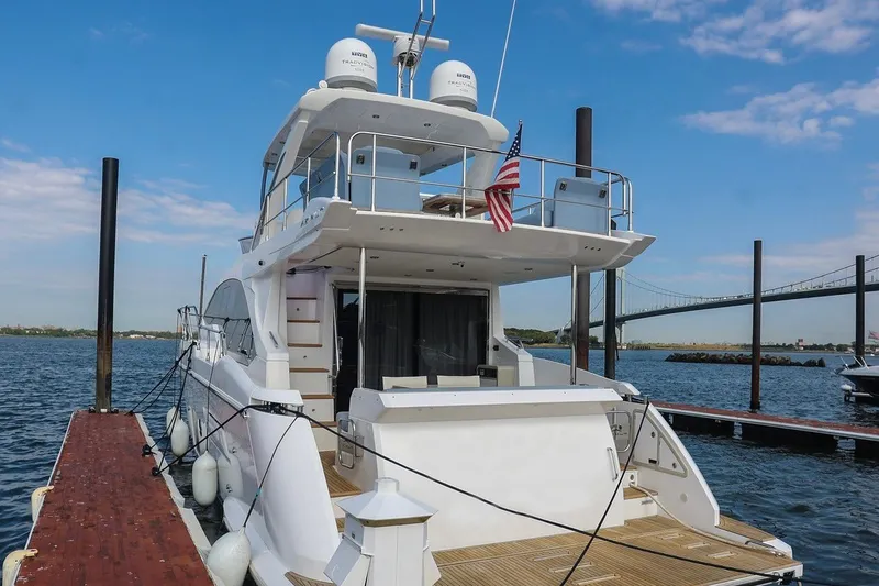 Slide: The Image of 2023 Azimut Fly 50 yacht docked at marina with bridge in background. - 3