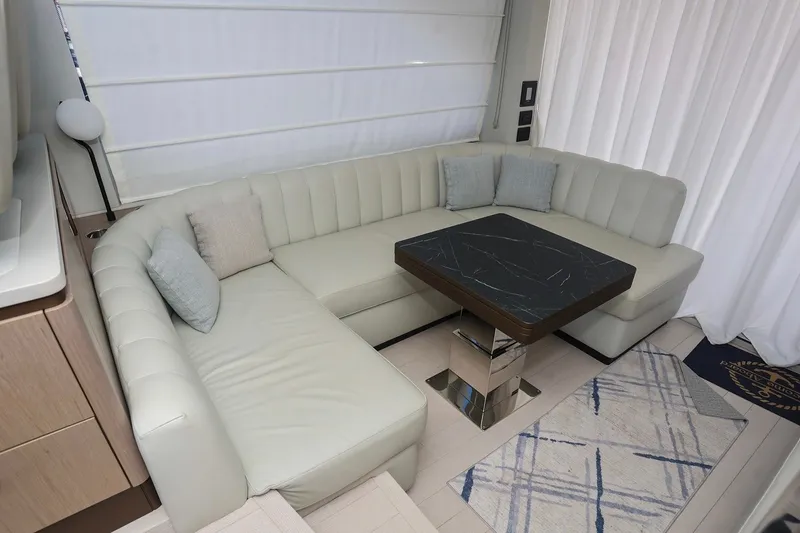Slide: The Image of Luxurious interior of 2023 Azimut Fly 50 yacht with elegant seating and modern table design. - 21