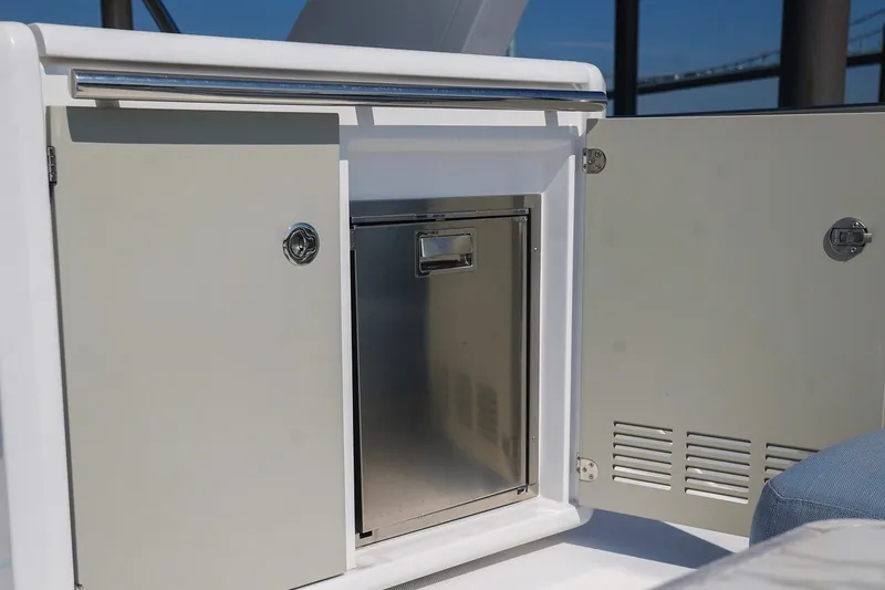 Slide: The Image of 2023 Azimut Fly 50 yacht interior with open storage compartment and stainless steel fridge. - 18