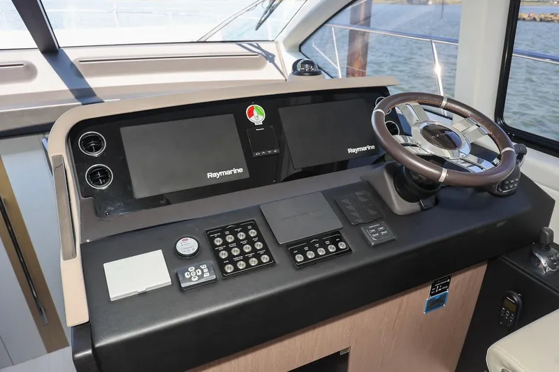 Slide: The Image of 2023 Azimut Fly 50 yacht helm with Raymarine navigation system and modern steering wheel. - 32