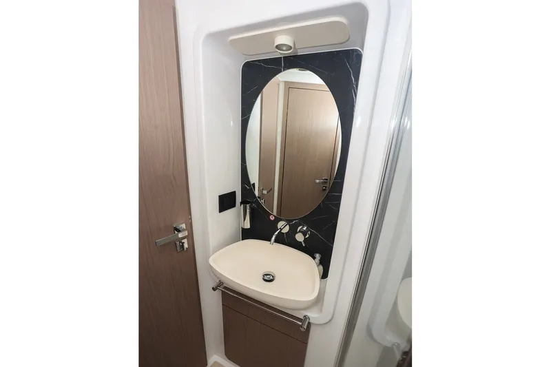 Slide: The Image of Modern bathroom interior on 2023 Azimut Fly 50 yacht, featuring sleek sink and mirror design. - 48