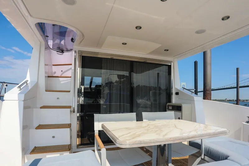 Slide: The Image of Luxurious 2023 Azimut Fly 50 yacht interior with elegant dining area and staircase. - 17