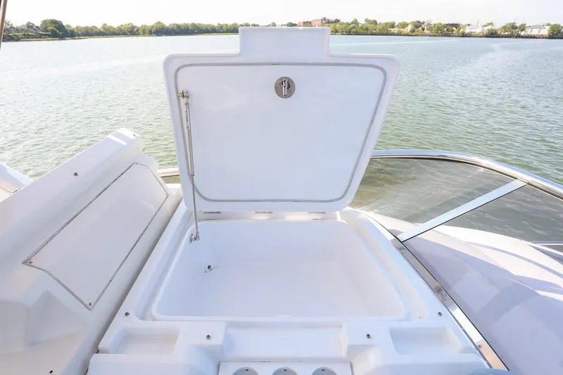 Slide: The Image of Open storage compartment on 2023 Azimut Fly 50 yacht, overlooking serene water. - 30