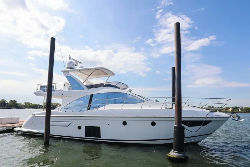 Slide: The Image of 2023 Azimut Fly 50 yacht docked on a sunny day, showcasing sleek design and luxury. - 56