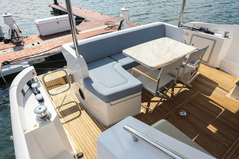 Slide: The Image of Luxurious 2023 Azimut Fly 50 yacht deck with elegant seating and table setup. - 44