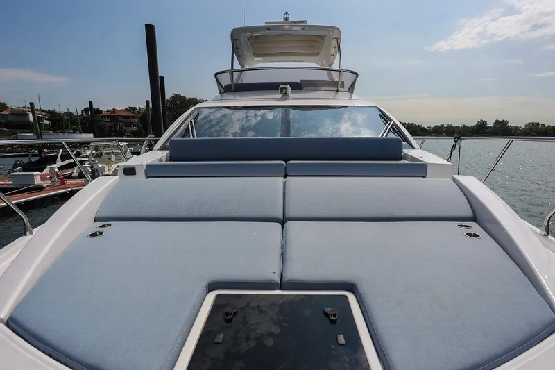 Slide: The Image of 2023 Azimut Fly 50 yacht with spacious sunbathing deck, docked by the water. - 28
