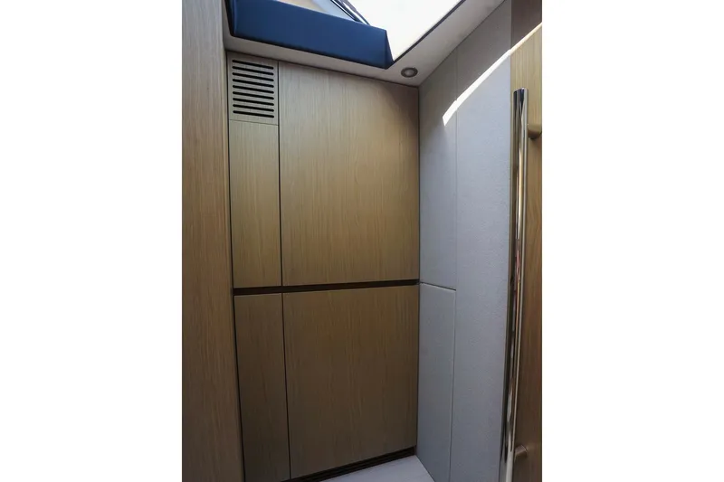 Slide: The Image of Interior of 2023 Azimut Fly 50 yacht with sleek wooden paneling and modern design. - 25