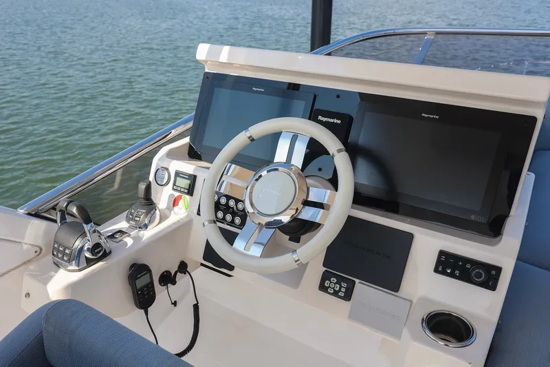 Slide: The Image of 2023 Azimut Fly 50 yacht helm with modern navigation displays and controls. - 6