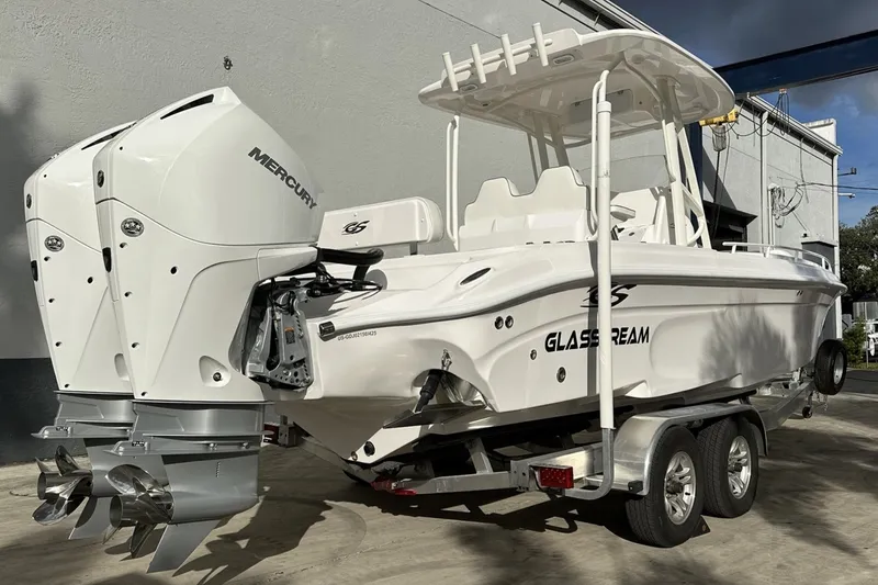 Slide: The Image of 2025 Glasstream 280 Pro-XS boat with dual Mercury engines on a trailer. - 2
