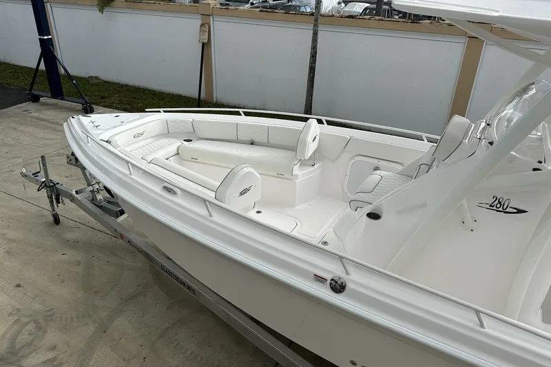 Slide: The Image of 2025 Glasstream 280 Pro-XS boat on trailer, featuring sleek white design and spacious seating. - 6