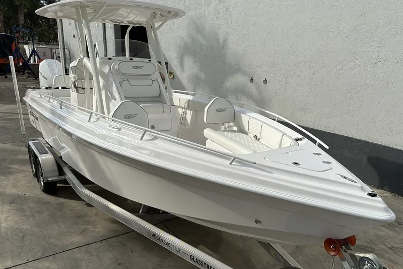 Slide: The Image of 2025 Glasstream 280 Pro-XS boat on trailer, sleek white design, parked outdoors. - 5