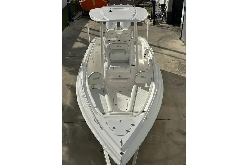 Slide: The Image of 2025 Glasstream 280 Pro-XS boat, sleek white design, docked in a marina. - 7