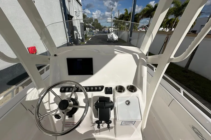 Slide: The Image of 2025 Glasstream 280 Pro-XS boat helm with steering wheel, controls, and display screen. - 24