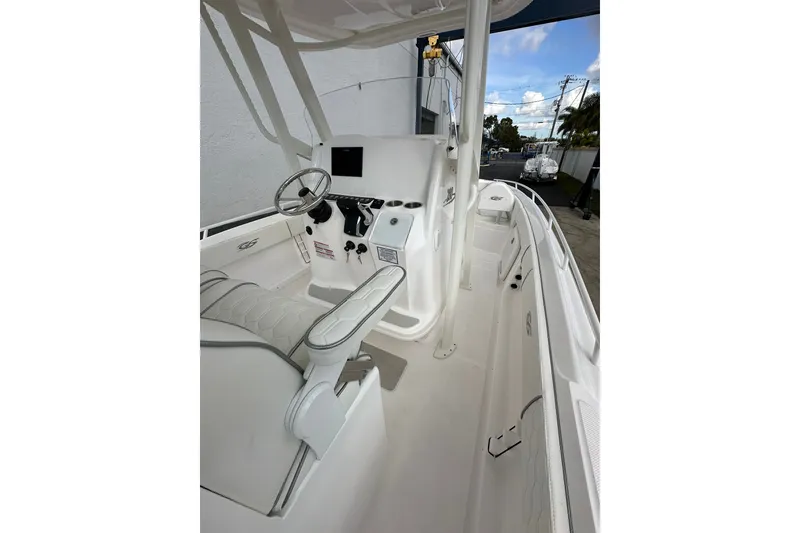 Slide: The Image of 2025 Glasstream 280 Pro-XS boat interior with steering wheel and seating. - 17