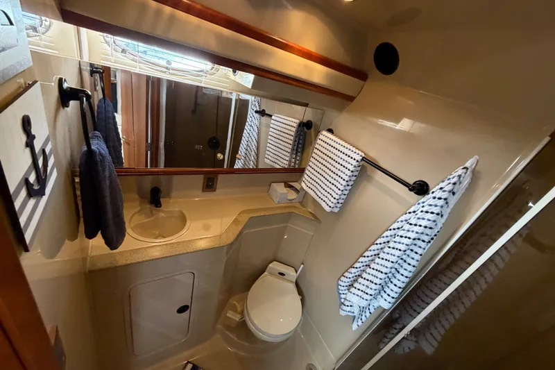 Slide: The Image of Bathroom interior of 2000 Cruisers Yachts 3870 Express with sink, toilet, and nautical decor. - 19