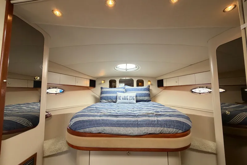Slide: The Image of Luxurious cabin interior of 2000 Cruisers Yachts 3870 Express with cozy bedding. - 15