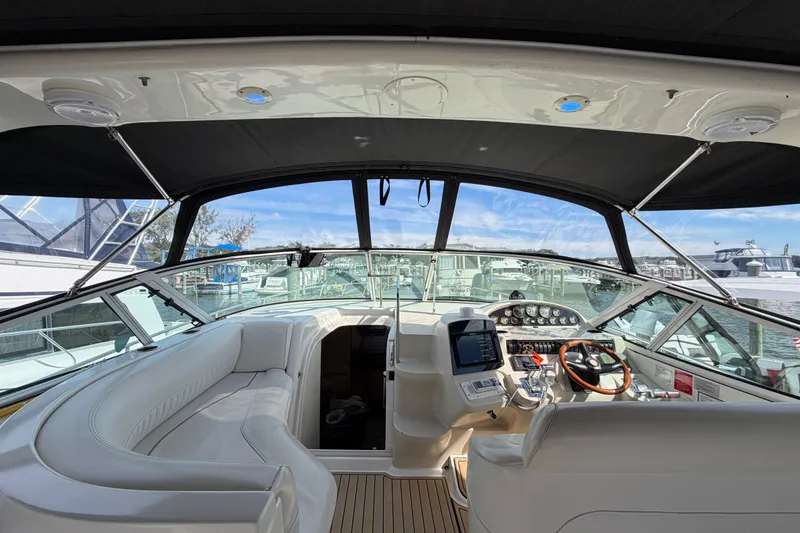 Slide: The Image of Cockpit view of 2000 Cruisers Yachts 3870 Express, featuring luxurious seating and modern controls. - 7
