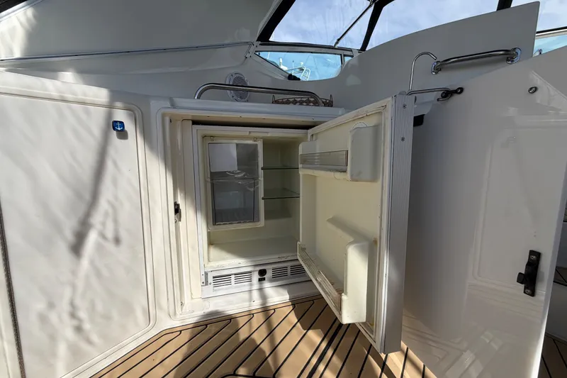 Slide: The Image of Open refrigerator on 2000 Cruisers Yachts 3870 Express boat deck. - 6
