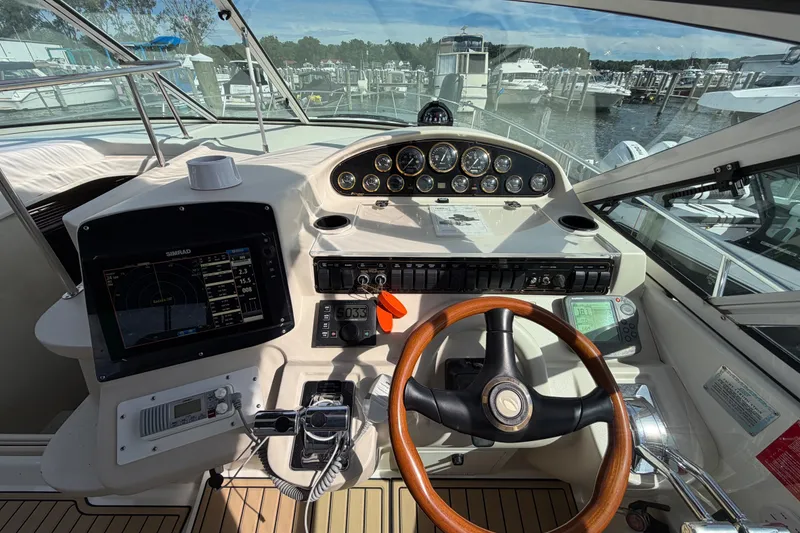 Slide: The Image of Cockpit of 2000 Cruisers Yachts 3870 Express with navigation instruments and wooden steering wheel. - 10