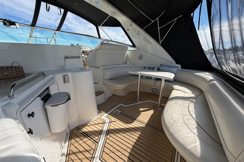Slide: The Image of Luxurious interior of 2000 Cruisers Yachts 3870 Express with seating and table. - 3