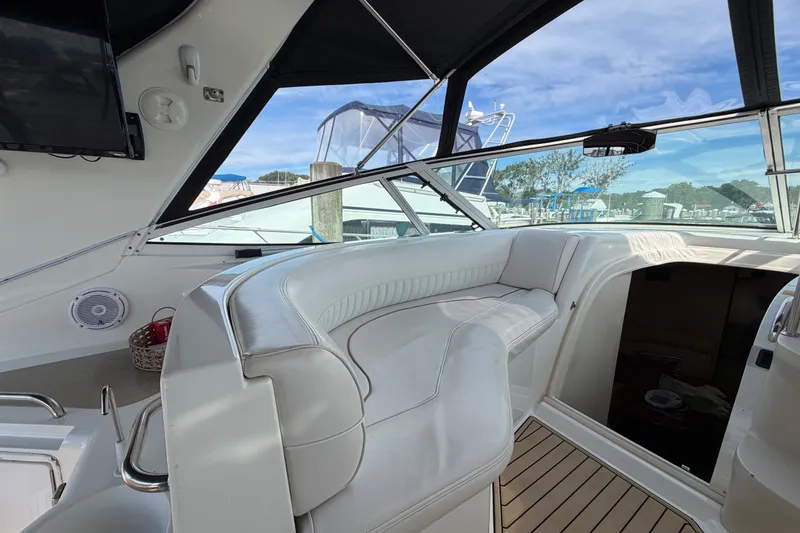Slide: The Image of 2000 Cruisers Yachts 3870 Express cockpit with white seating and modern amenities. - 8