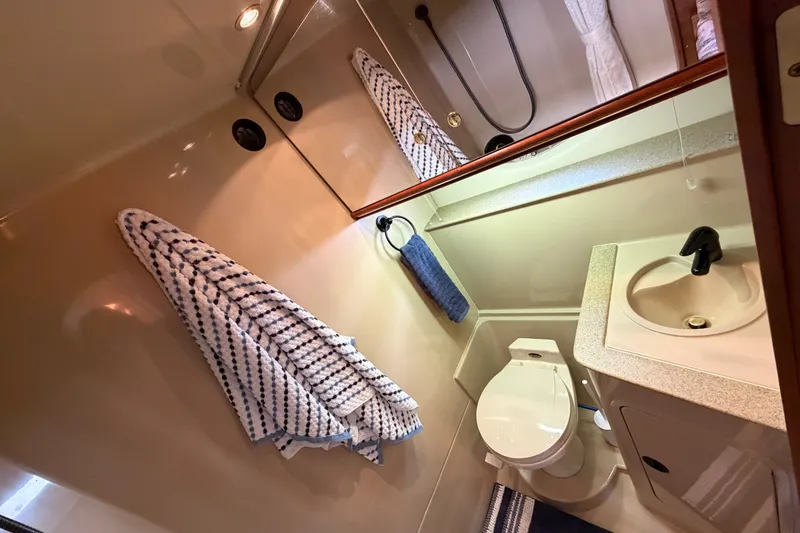 Slide: The Image of Bathroom interior of 2000 Cruisers Yachts 3870 Express, featuring sink, toilet, and shower. - 24
