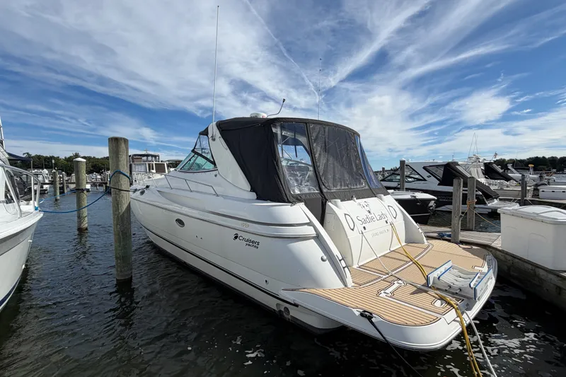 Slide: The Image of 2000 Cruisers Yachts 3870 Express docked at marina under blue sky. - 1