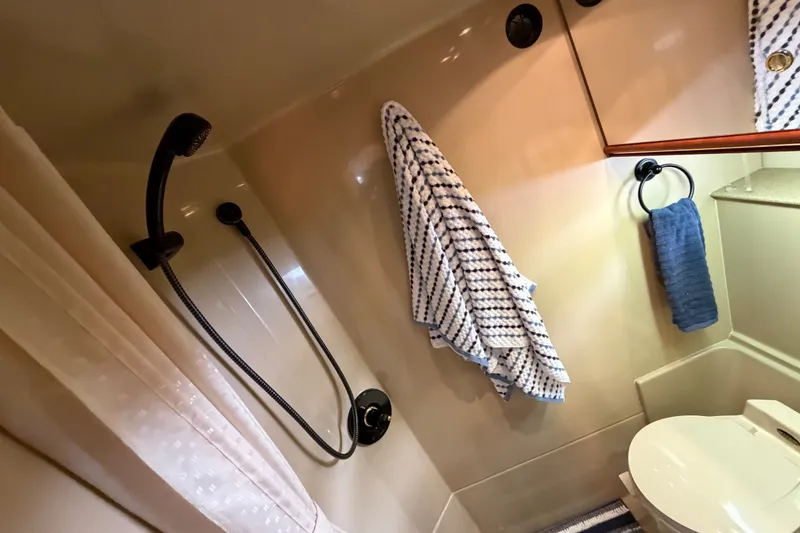 Slide: The Image of Bathroom interior of 2000 Cruisers Yachts 3870 Express with shower and towels. - 23