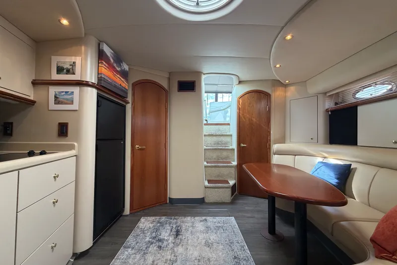 Slide: The Image of Interior of 2000 Cruisers Yachts 3870 Express, featuring cozy seating and modern amenities. - 18