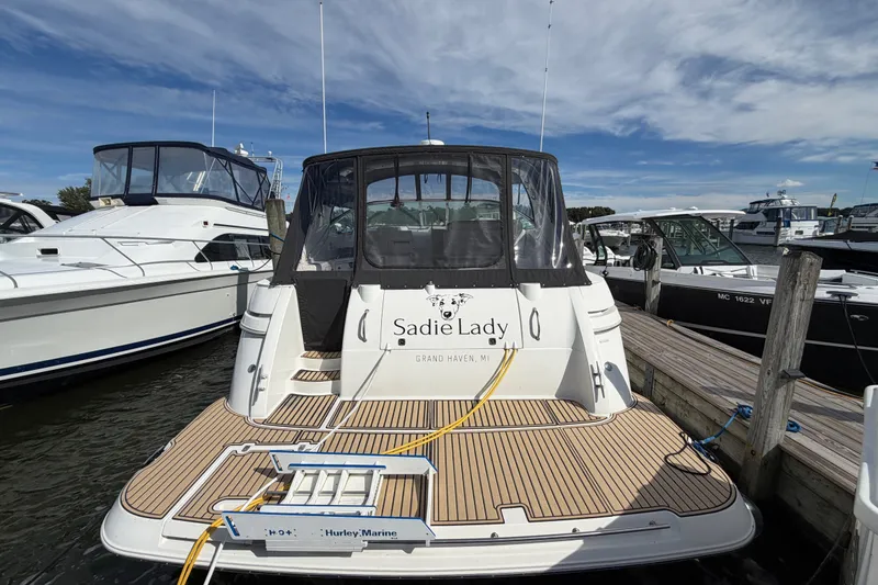 Slide: The Image of 2000 Cruisers Yachts 3870 Express docked, rear view with "Sadie Lady" name visible. - 2