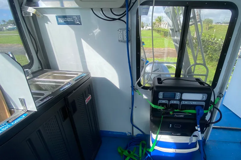 Slide: The Image of Interior of a 2019 Solid Craft Commercial Pontoon with sink and power station. - 16