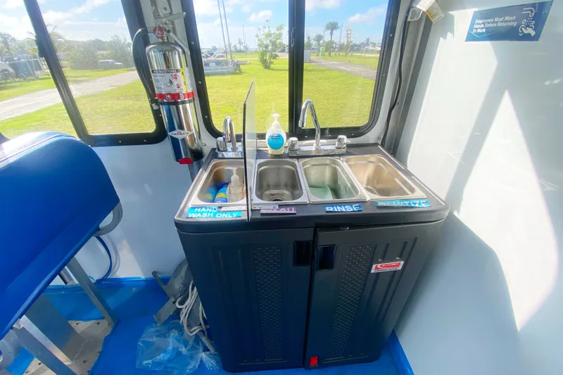 Slide: The Image of Three-compartment sink on 2019 Solid Craft Commercial Pontoon, featuring hand wash, rinse, sanitize stations. - 15