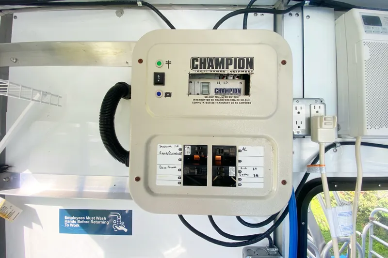 Slide: The Image of Electrical panel inside a 2019 Solid Craft Commercial Pontoon, featuring Champion transfer switch. - 17