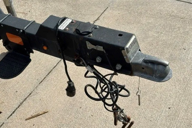 Slide: The Image of Trailer hitch of a 2019 Sun Tracker Fishin' Barge 24 DLX on concrete surface. - 12