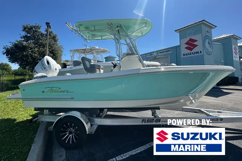 The Image of 2027 Pioneer 202 Islander boat on trailer, powered by Suzuki Marine, in sunny outdoor setting. - 0